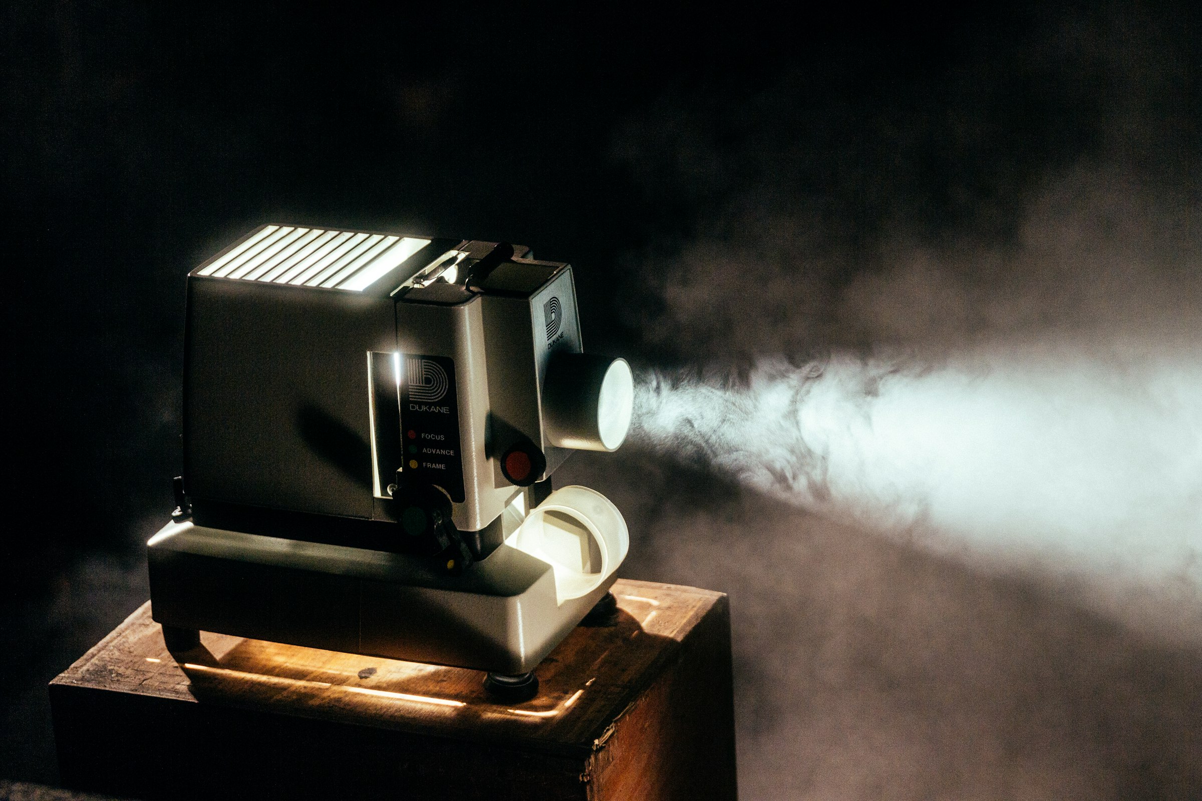 Film projector casting a beam of light in the dark